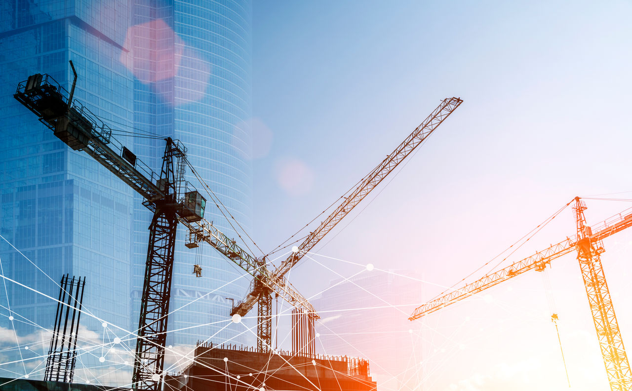 Construction technology banner background. Construction site with cranes, fittings and concrete. High quality photo